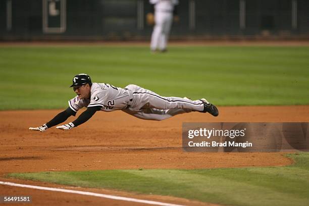 Scott Podsednik of the Chicago White Sox slides into third base with a triple during Game Four of the Major League Baseball World Series against the...