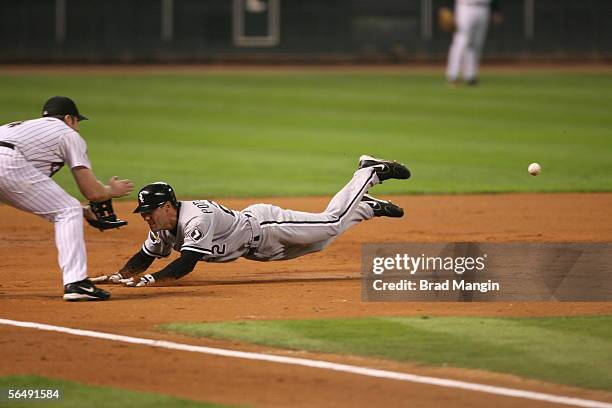 Scott Podsednik of the Chicago White Sox slides into third base with a triple during Game Four of the Major League Baseball World Series against the...