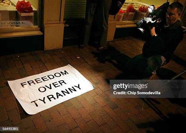 Television camera man photographs one of the demonstration signs used during a "Freedom From Terror" vigil across the street from the Interests...