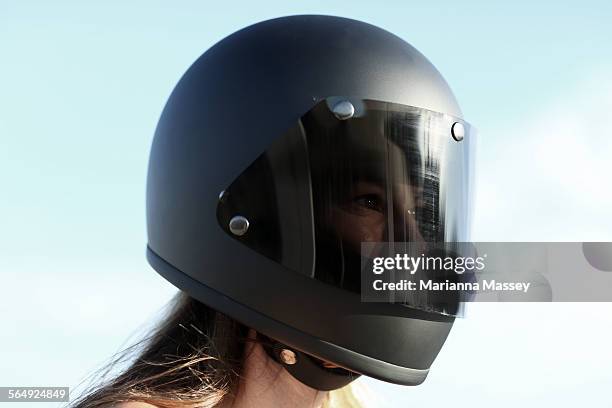 woman wearing a motorcycle helmet - crash helmet stock-fotos und bilder