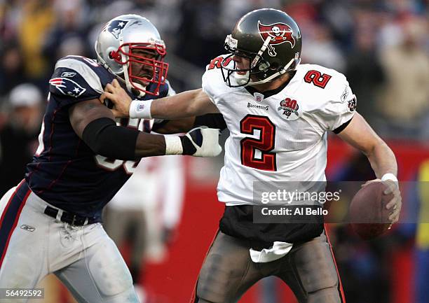 Chris Simms of the Tampa Bay Buccaneers tries avoid a sack by Willie McGinest of the New England Patriots during the NFL game on December 17, 2005 at...