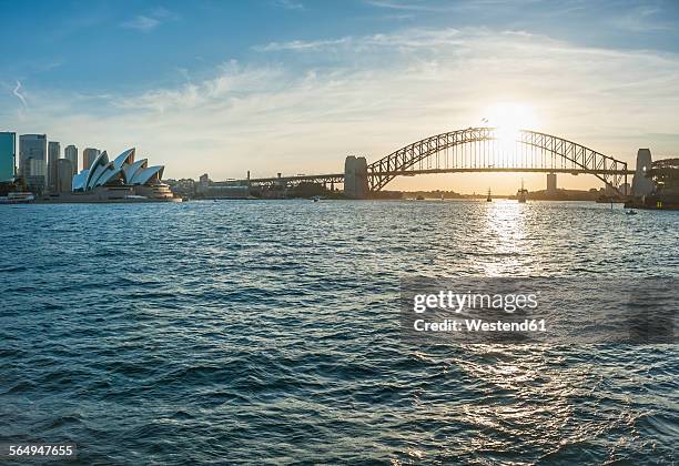 australia, new south wales, sydney, skyline with sydney harbour bridge and sydney opera house at sunset - sydney opera house fotografías e imágenes de stock