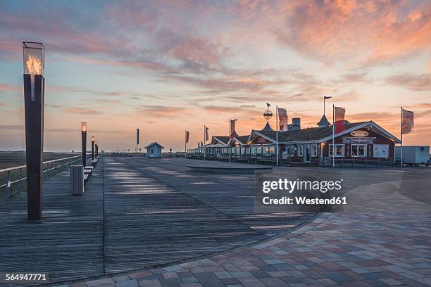 germany, schleswig-holstein, st peter-ording, sunset at pier - sankt peter ording stock pictures, royalty-free photos & images