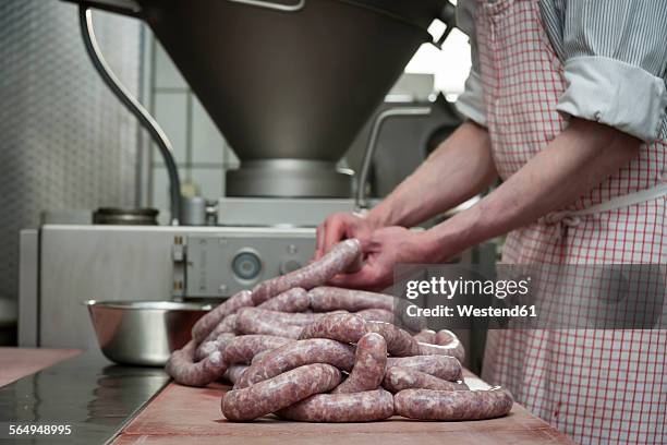 preparation of smoked sausage, butcher filling sausage casing - stuffing stock-fotos und bilder
