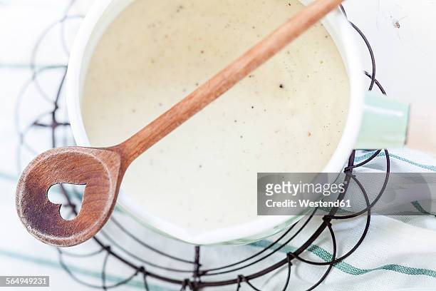 saucepan of homemade vanilla custard and cooking spoon - wooden spoon stock pictures, royalty-free photos & images