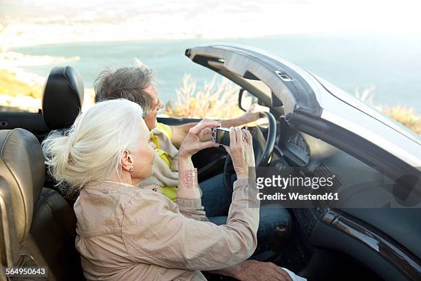 south africa, senior couple sitting in a convertible looking at view - toyota south africa motors stock pictures, royalty-free photos & images