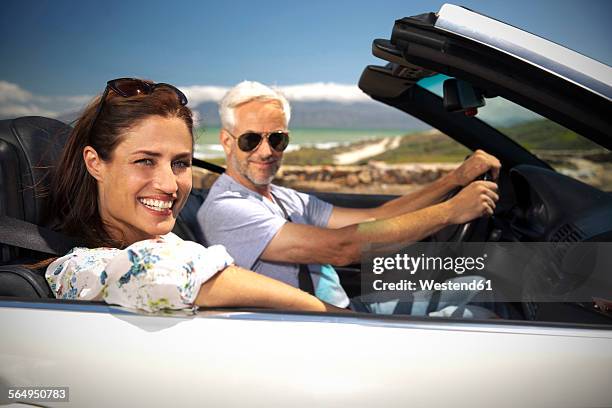 south africa, portrait of smiling couple sitting in a convertible - toyota south africa motors stock pictures, royalty-free photos & images