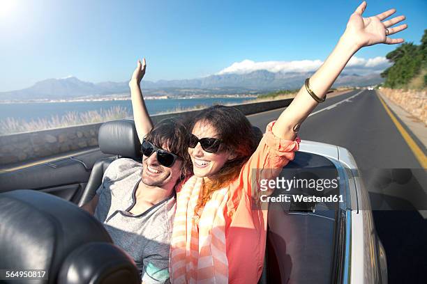south africa, happy couple in convertible on coastal road - toyota south africa motors stock pictures, royalty-free photos & images