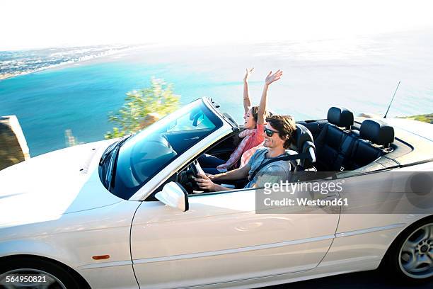 south africa, happy couple in convertible on coastal road - toyota south africa motors stock pictures, royalty-free photos & images