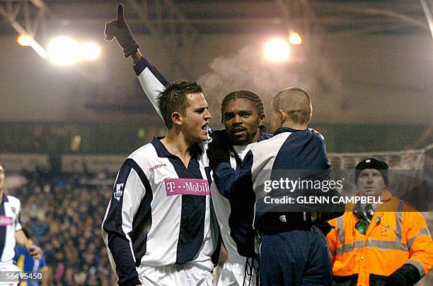 West Bromwich, UNITED KINGDOM: West Bromwich Albion's Nwankwo Kanu celebrates with a ballboy and Daren Carter after he scored his second goal in the...