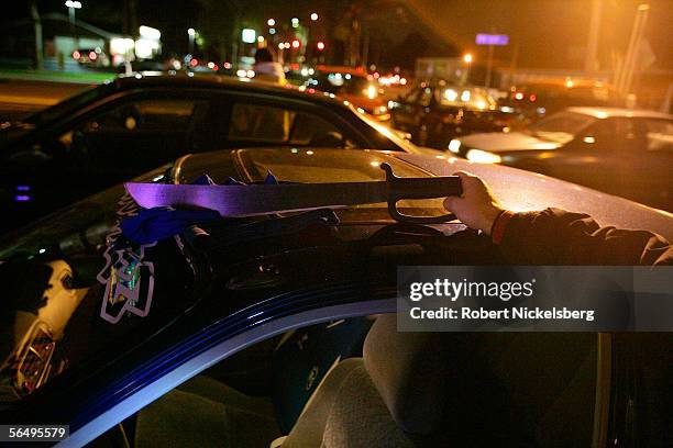 Suffolk County Police officer holds a machete that was found in a vehicle belonging to suspected MS-13 gang members October 27, 2005 in Brentwood,...