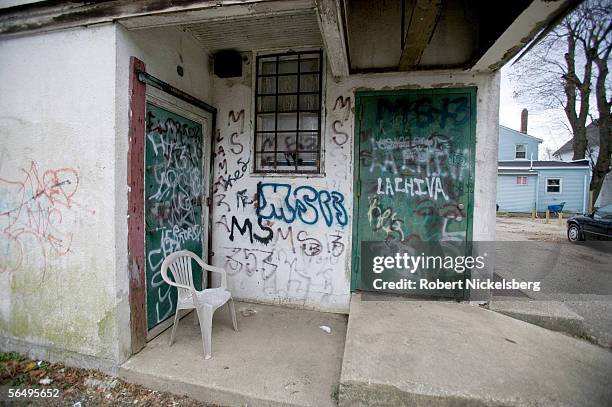 Suffolk County Police from the anti-gang unit keep track of graffiti painted by MS-13, a violent Central American street gang December 1, 2005 in...