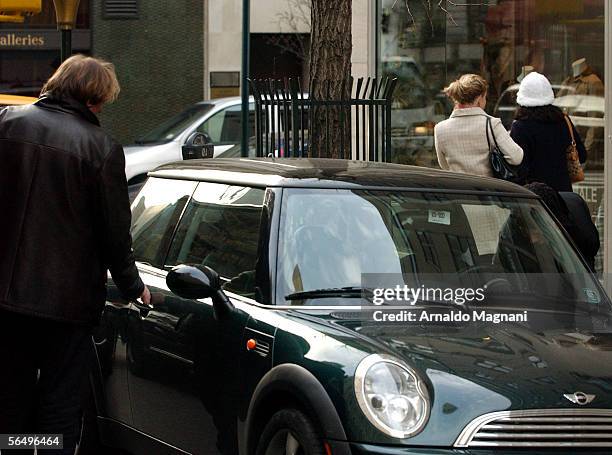 Gerard Depardieu gets into a car with Clementine Igou on December 28, 2005 in New York City.