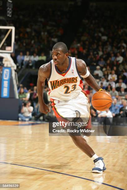 Jason Richardson of the Golden State Warriors dribbles against the Phoenix Suns during the game at The Arena in Oakland on December 7, 2005 in...