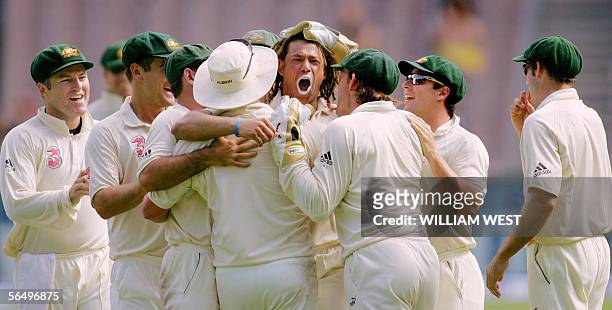 Australian bowler Andrew Symonds is congratulated after dismissing South Africa batsman Jacques Kallis on the fourth day of the second Test Match...