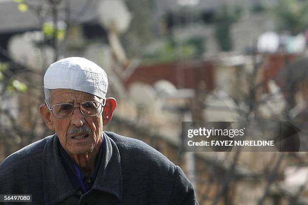 An Algerian elderly man wears a traditional hat as he walks on a main street near the "Memorial of Martyrs" in Reyad Al-Fath in Algiers City 29...