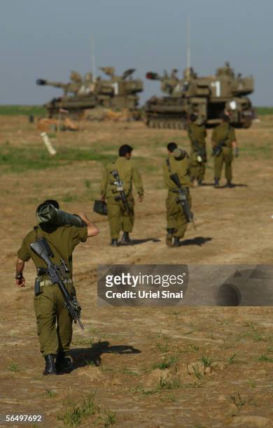 Israeli army soldiers prepare ammunition for their 155mm mobile artillery cannon after a night of action against Palestinian militants in the...