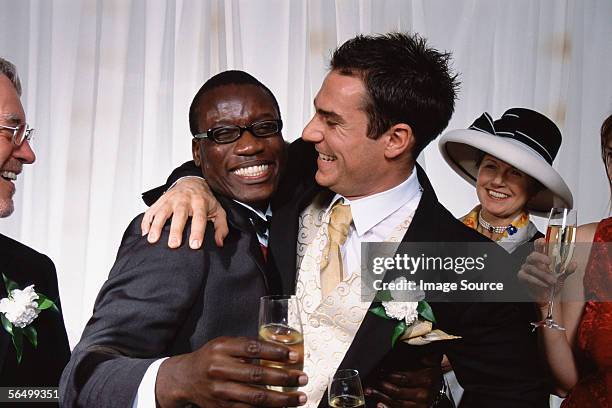 groom hugs best man - drunk husband stock pictures, royalty-free photos & images