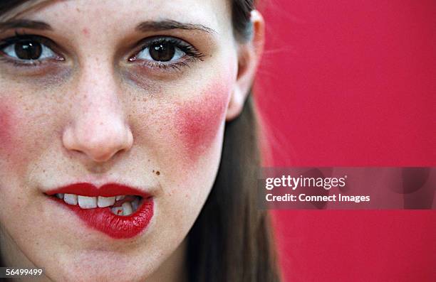 woman biting her lip - cheek stock pictures, royalty-free photos & images