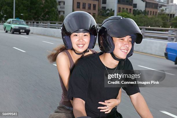 Young Asian Couple On Moped High-Res Stock Photo