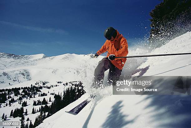 man skiing down mountainside - colorado skiing stock pictures, royalty-free photos & images