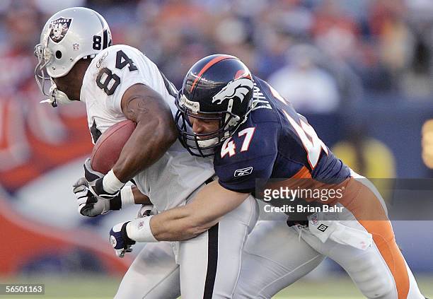 Safety John Lynch of the Denver Broncos attempts to tackle Jerry Porter of the Oakland Raiders during the game on December 24, 2005 at Invesco Field...