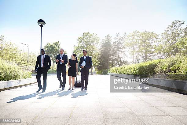 business men and woman walk and chat together - business park stockfoto's en -beelden