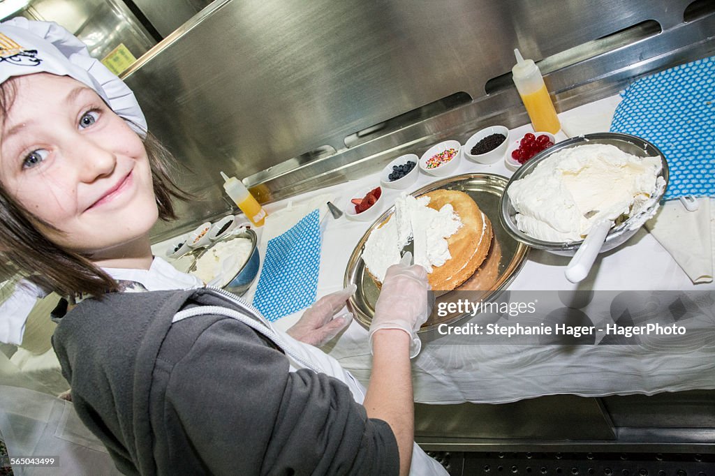 Girl frosting cake