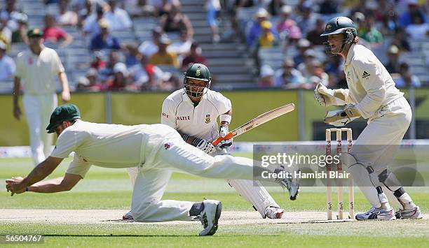 Ashwell Prince of South Africa and Adam Gilchrist of Australia look back to see Matthew Hayden of Australia take a catch to dismiss Prince during day...