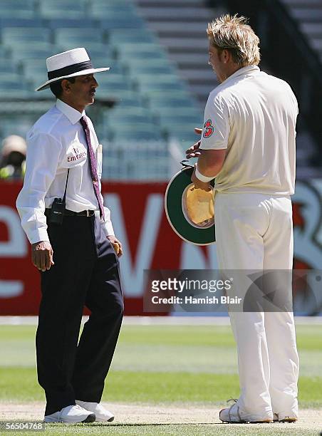 Umpire Asad Rauf discusses a decision with Shane Warne of Australia during day five of the Second Test between Australia and South Africa played at...
