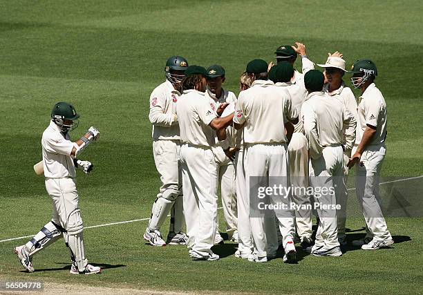 Shane Warne of Australia is congratulated by team mates after taking the wicket of Ashwell Prince during day five of the Second Test between...