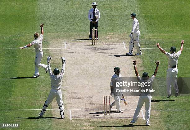 Shane Warne of Australia leads his team mates in a successful appeal to Umpire Asad Rauf against Ashwell Prince of South Africa during day five of...