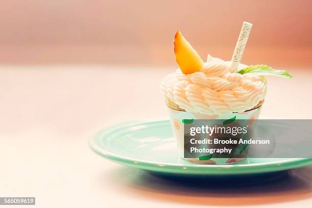 peach mojito cupcake on plate with peach slice and - peach slice stock pictures, royalty-free photos & images