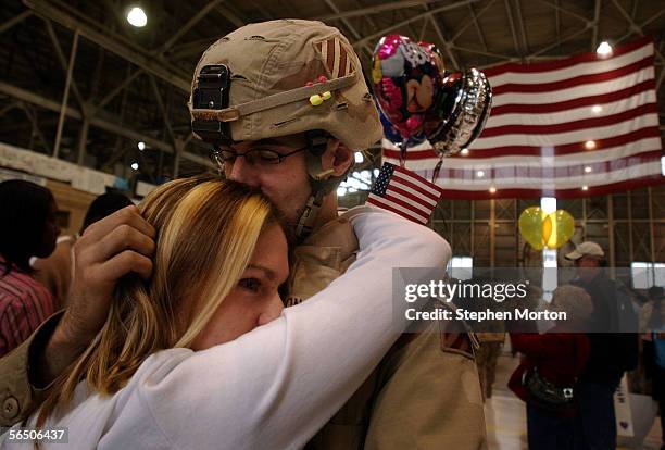 Army Spc. Bradley Johnson is greeted by his wife Beth Johnson during a welcome home ceremony at Hunter Army Airfield December 30, 2005 in Savannah,...