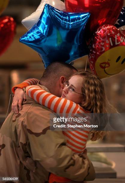 Army Spc. Todd Chirstensen is greeted by his wife Shelley Christensen during a welcome home ceremony at Hunter Army Airfield December 30, 2005 in...