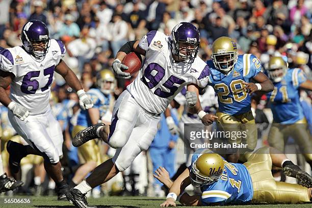 Defensive end Kevin Mims of the Northwestern Wildcats takes an interception for a touchdown against Drew Olson of the UCLA Bruins in the first...