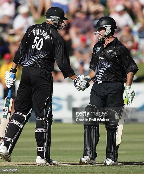 Peter Fulton of New Zealand congratulates team-mate Jamie How on his half century on debut during the first One Day International match between New...