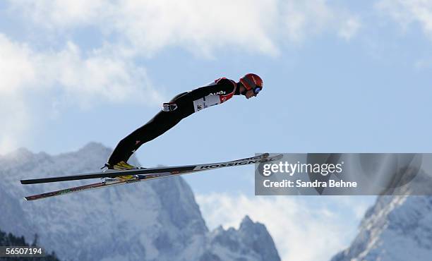 Michael Uhrmann of Germany soars through the air in front of the mountain Zugspitze during training for the FIS Ski Jumping World Cup event at the...