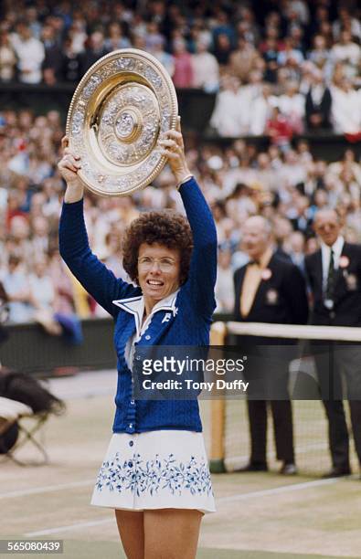 Billie Jean King of the United States holds aloft the Venus Rosewater Dish for the sixth time after defeating against Evonne Goolagong Cawley for the...