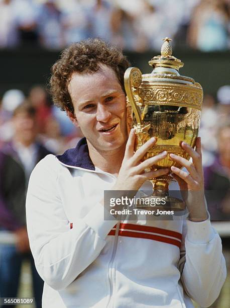 John McEnroe of the United States holds aloft the championship trophy after defeating Jimmy Connors to win the Men's Singles Final match at the...