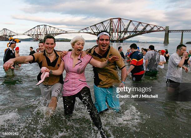 New Year revellers plunge into the River Forth in front of the Forth Rail Bridge during the Loony Dook Swim on January 1, 2006 at South Queensferry,...