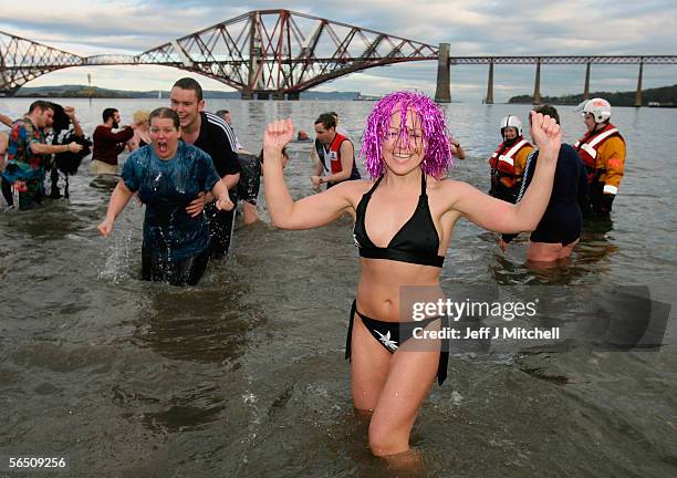 New Year revellers plunge into the River Forth in front of the Forth Rail Bridge during the Loony Dook Swim on January 1, 2006 at South Queensferry,...