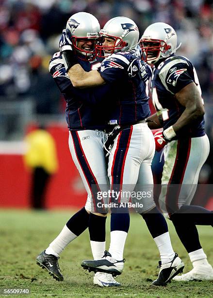 Doug Flutie of the New England Patriots celebrates with Josh Miller after successfully drop kicking an extra point after a touchdown in the fourth...