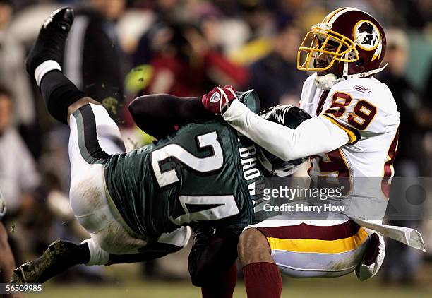 Wide receiver Santana Moss of the Washington Redskins tackles Sheldon Brown of the Philadelphia Eagles after an interception that was called back in...