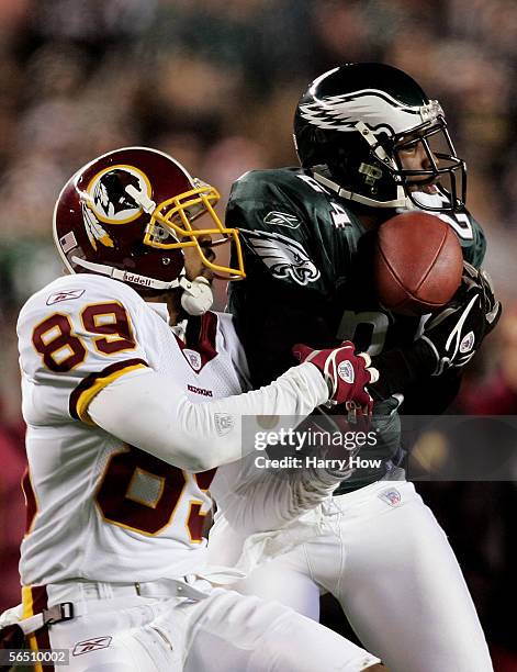 Sheldon Brown of the Philadelphia Eagles makes a catch in front of wide receiver Santana Moss of the Washington Redskins for an interception that was...