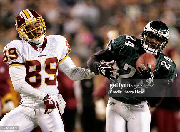 Sheldon Brown of the Philadelphia Eagles makes a catch in front of wide receiver Santana Moss of the Washington Redskins for an interception that was...