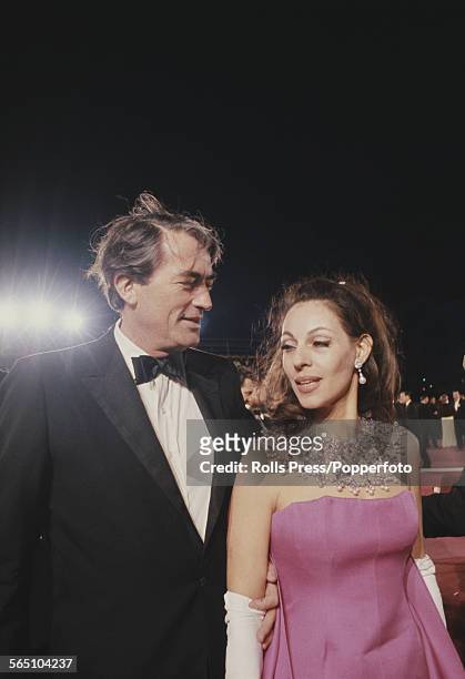 American actor Gregory Peck pictured with his wife Veronique Passani attending the 39th Academy Awards at the Santa Monica Civic Auditorium in...