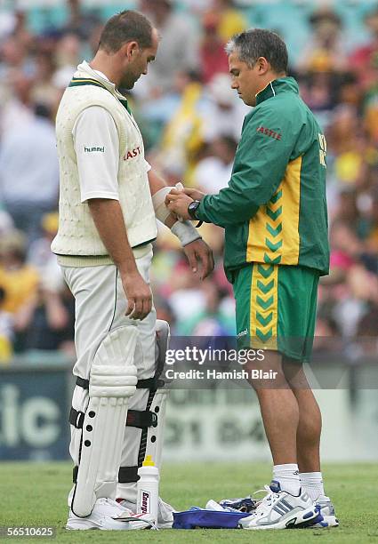 Jacques Kallis of South Africa receieves treatment to his elbow during day one of the Third Test between Australia and South Africa played at the SCG...