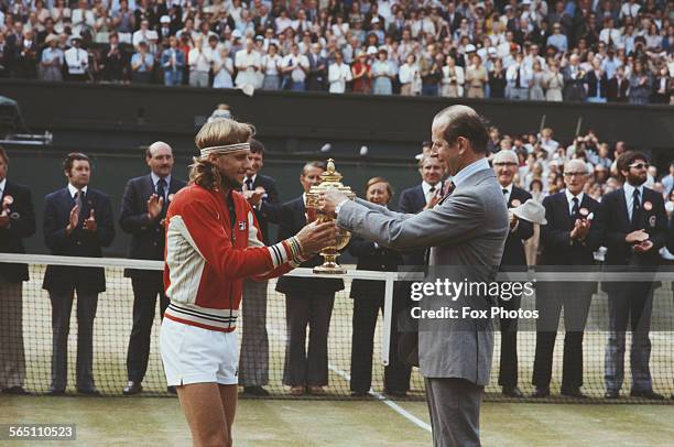 Bjorn Borg of the Sweden receives the Gentleman's Singles trophy from Prince Edward, Duke of Kent after defeating Roscoe Tanner to win the Men's...