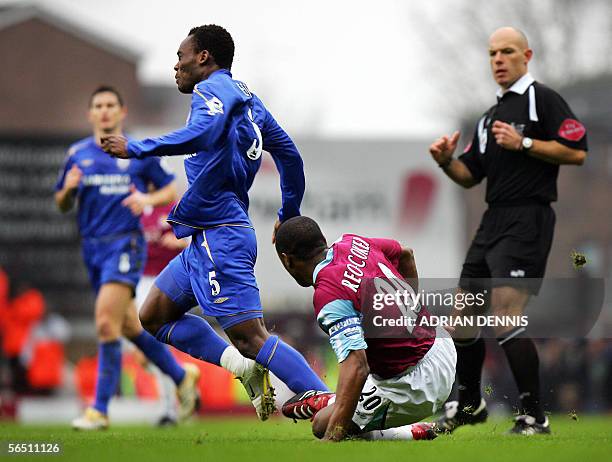 London, UNITED KINGDOM: West Ham's Nigel Reo-Coker slides in to tackle Mickael Essien of Chelsea during the Premiership football match at Upton Park...